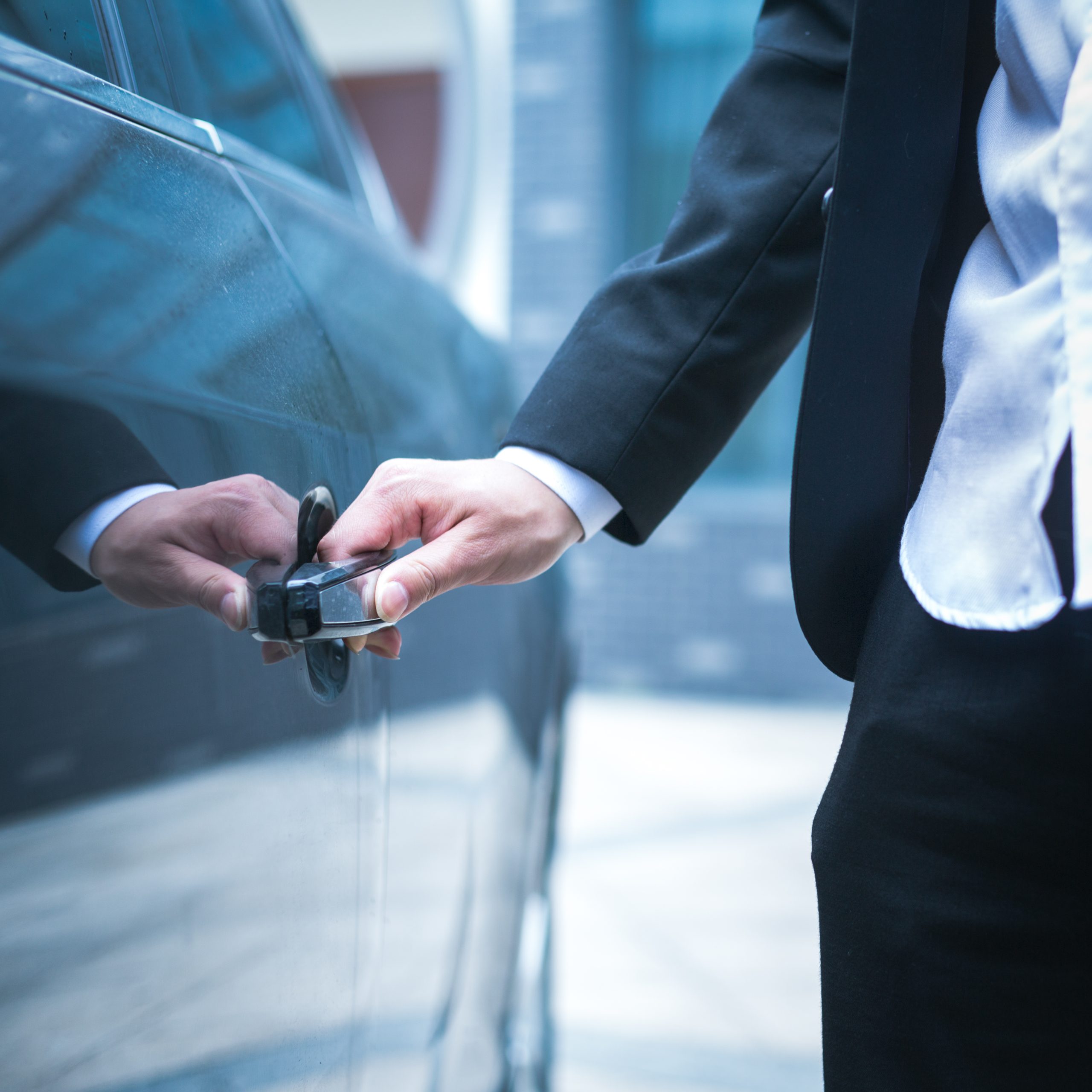 Hand of businessman opening door of car Hand of businessman opening door of car